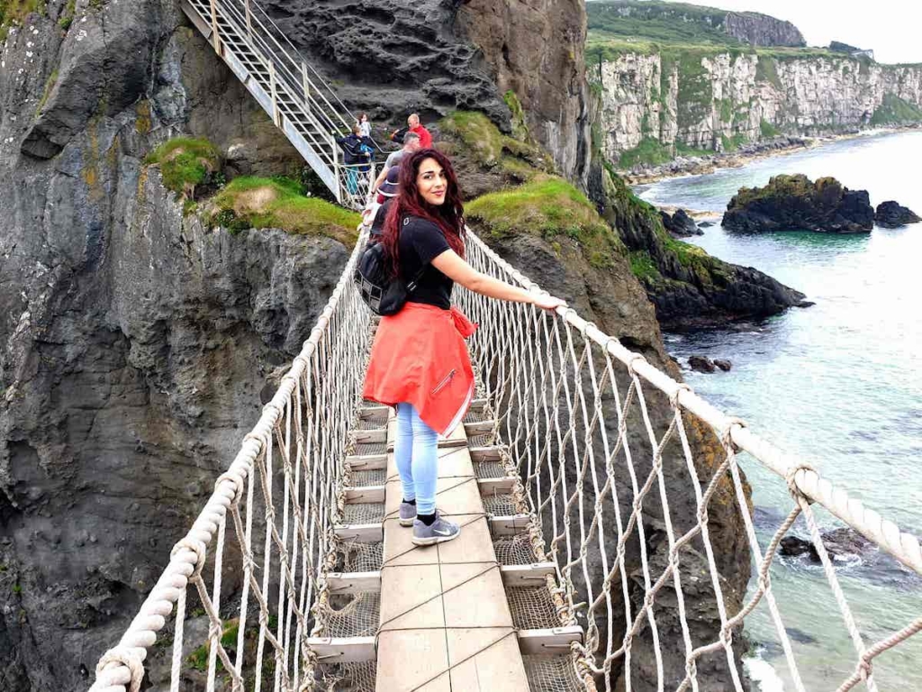Tonia crossing the Carrick-A-rede-rope Bridge in Northern Ireland near Giants Causeway
